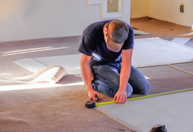 Redicut Carpets Expert Measuring carpets of a home in White Plains.