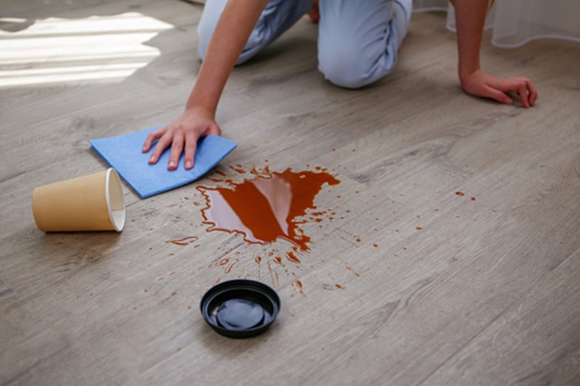 A man cleaning spilled juice on a waterproof floor in Westchester County