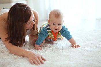 Baby playing on carpet